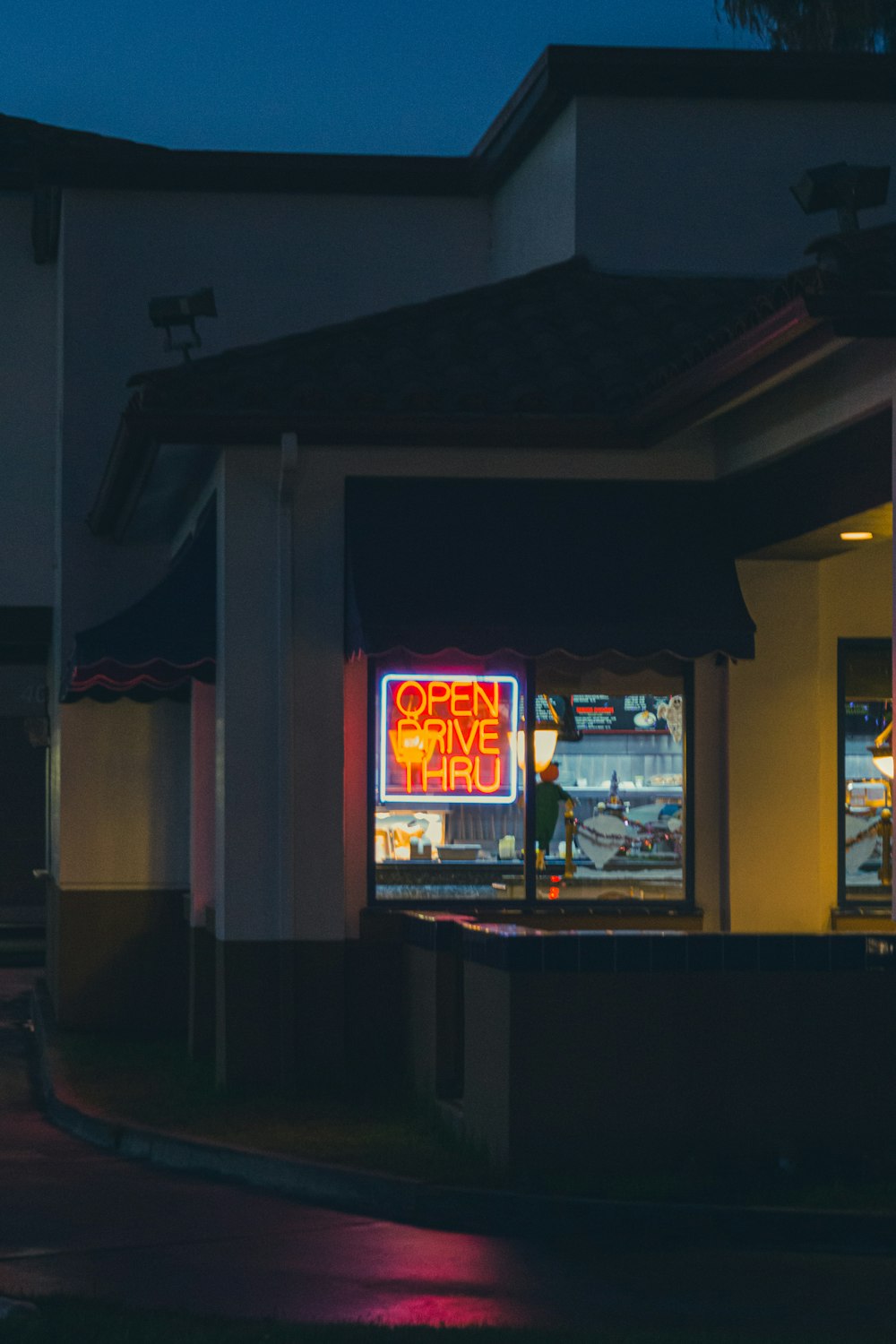 a store front at night with a neon sign