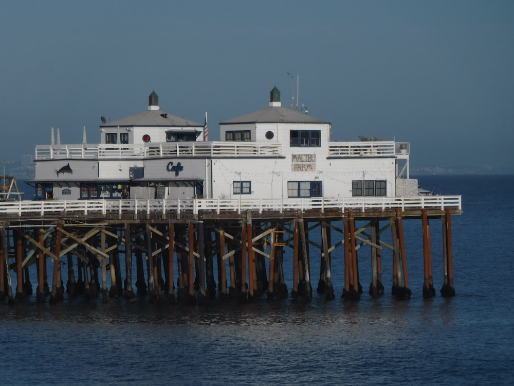 a large white building sitting on top of a pier