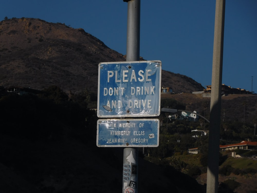 a blue and white street sign sitting on the side of a road