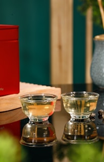 A serene setting with traditional hijama cups arranged neatly on a wooden tray, soft natural light highlighting their glass surfaces.