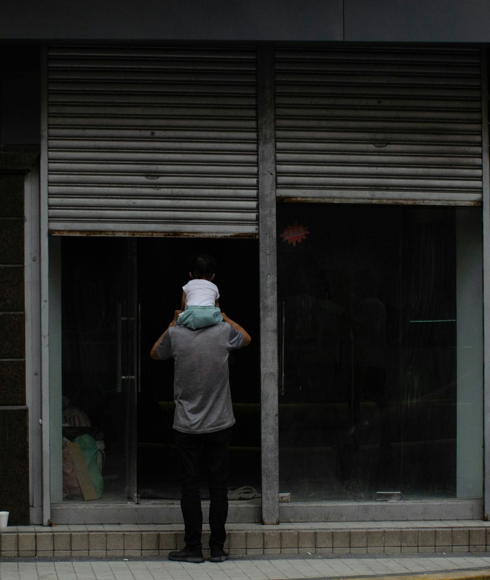 a man standing in front of a store window