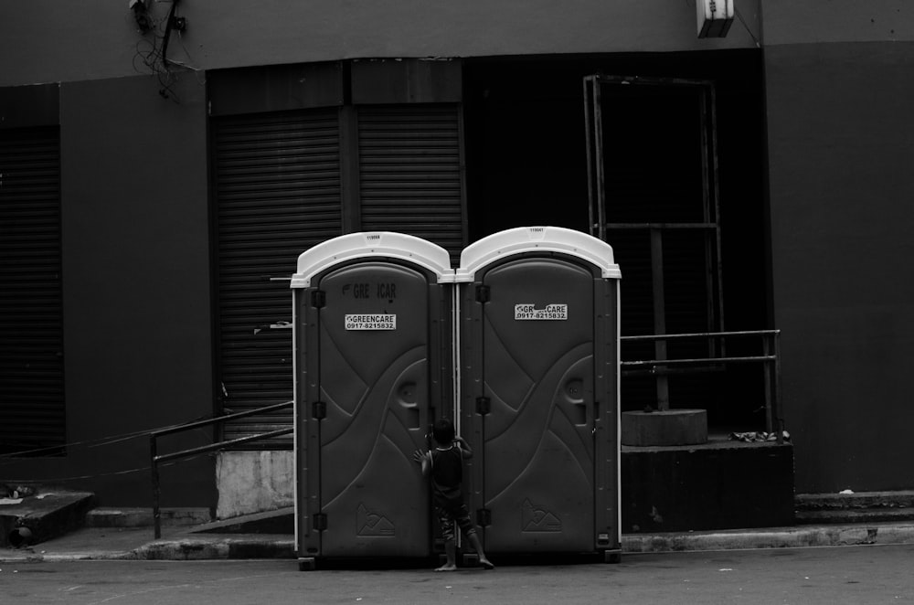 a couple of portable toilets sitting in front of a building