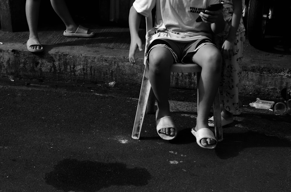 a person sitting on a chair with a cell phone