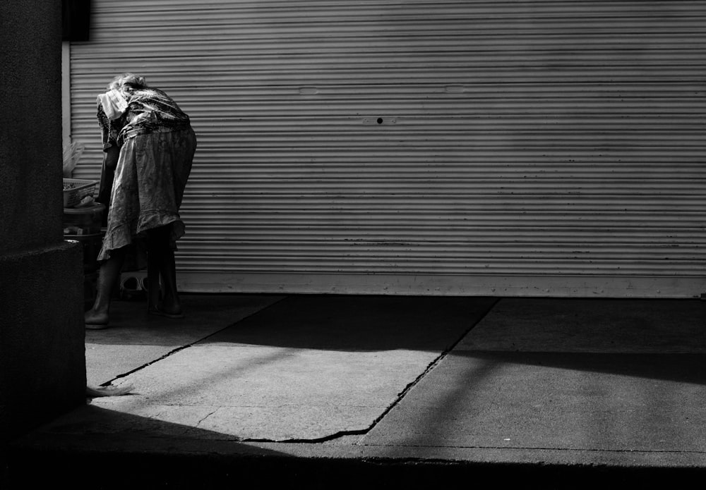 a woman standing in front of a garage door