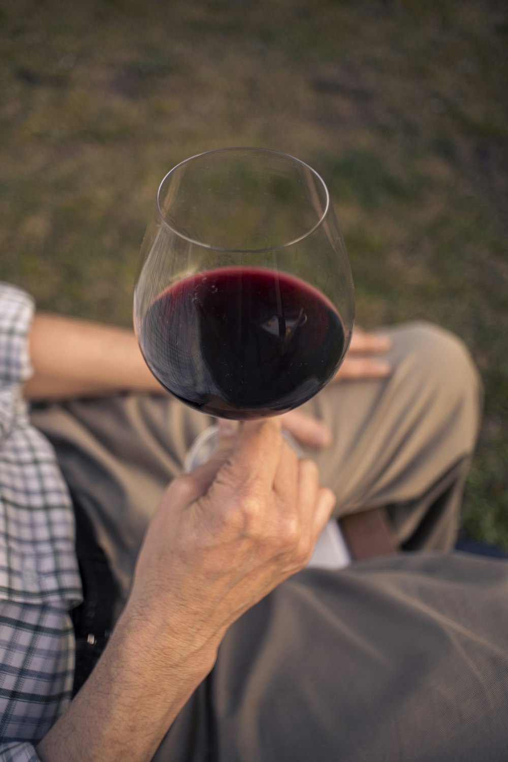 a man holding a glass of red wine