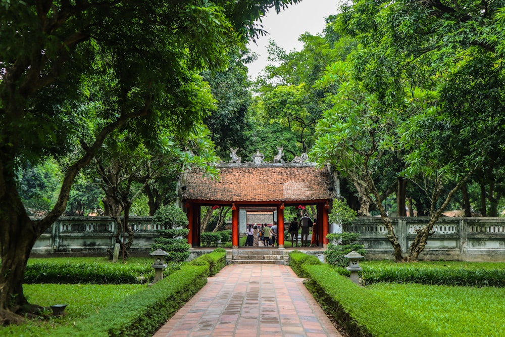 a small building surrounded by lush green trees