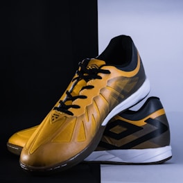 a pair of yellow and black tennis shoes