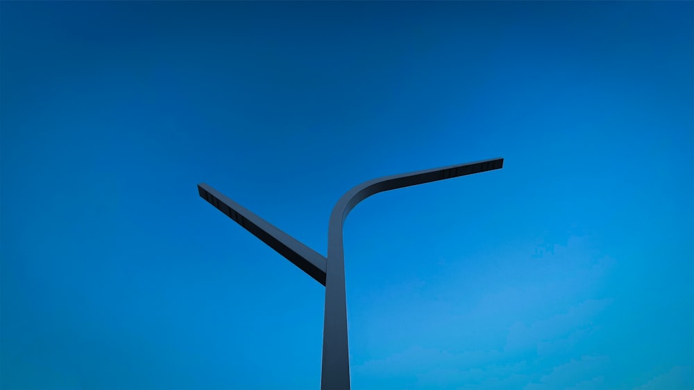 a street light with a blue sky in the background