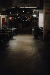 a dimly lit restaurant with tables and chairs