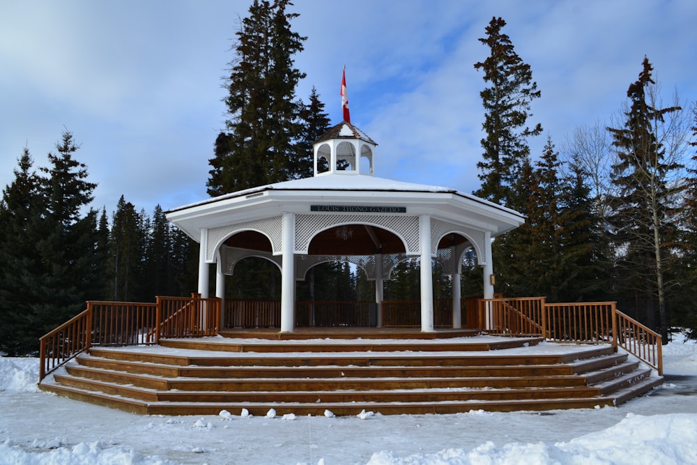 a gazebo in the snow with steps leading up to it