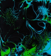 a black and blue background with green and black swirls