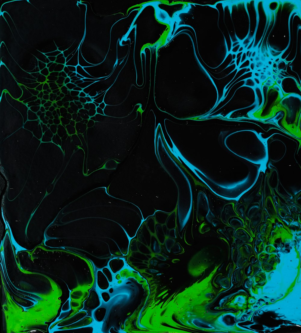 a black and blue background with green and black swirls