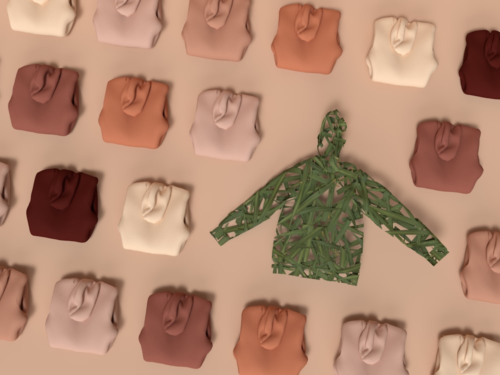 a paper cutout of a green shirt in front of a wall of colored paper