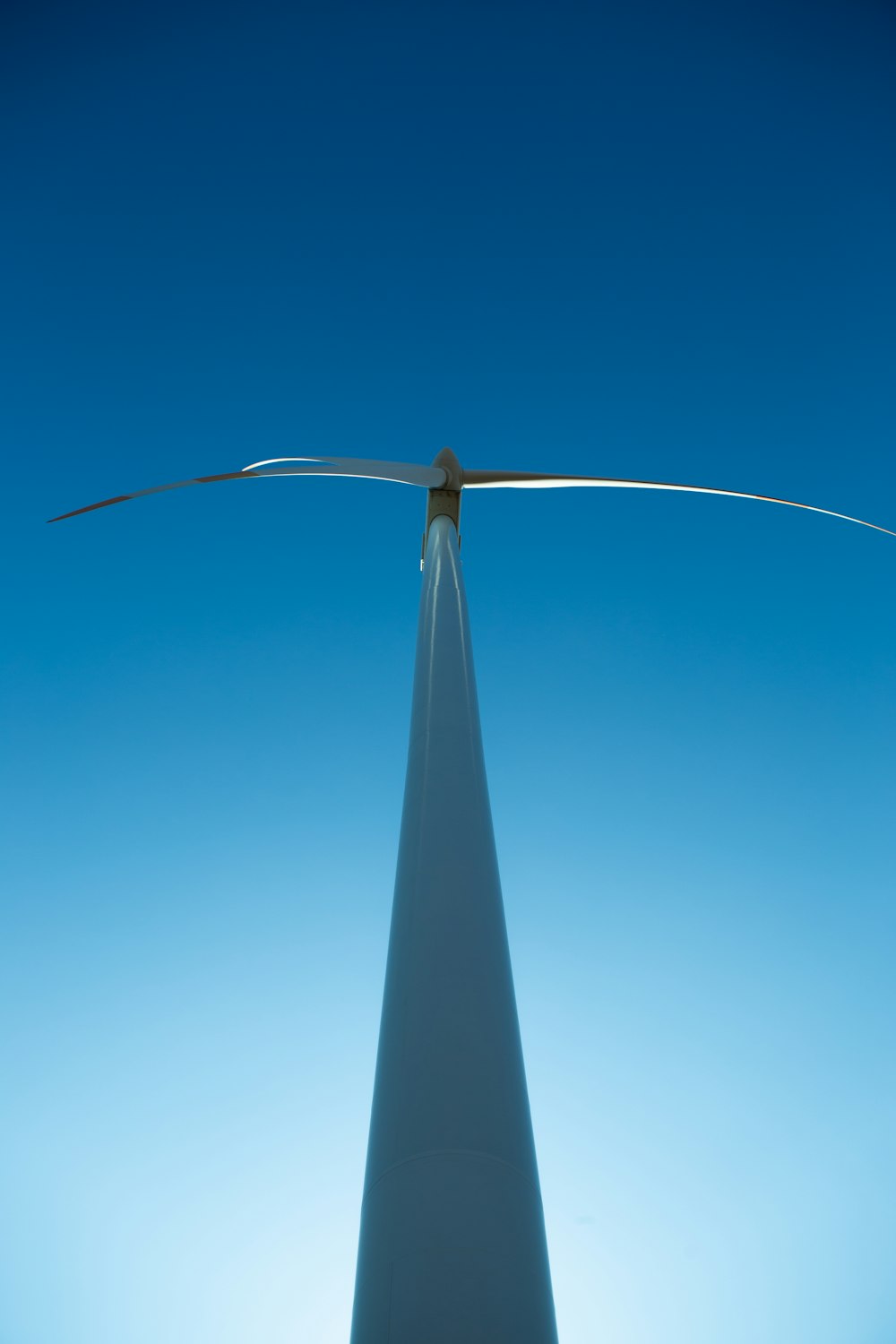 a wind turbine is shown against a blue sky