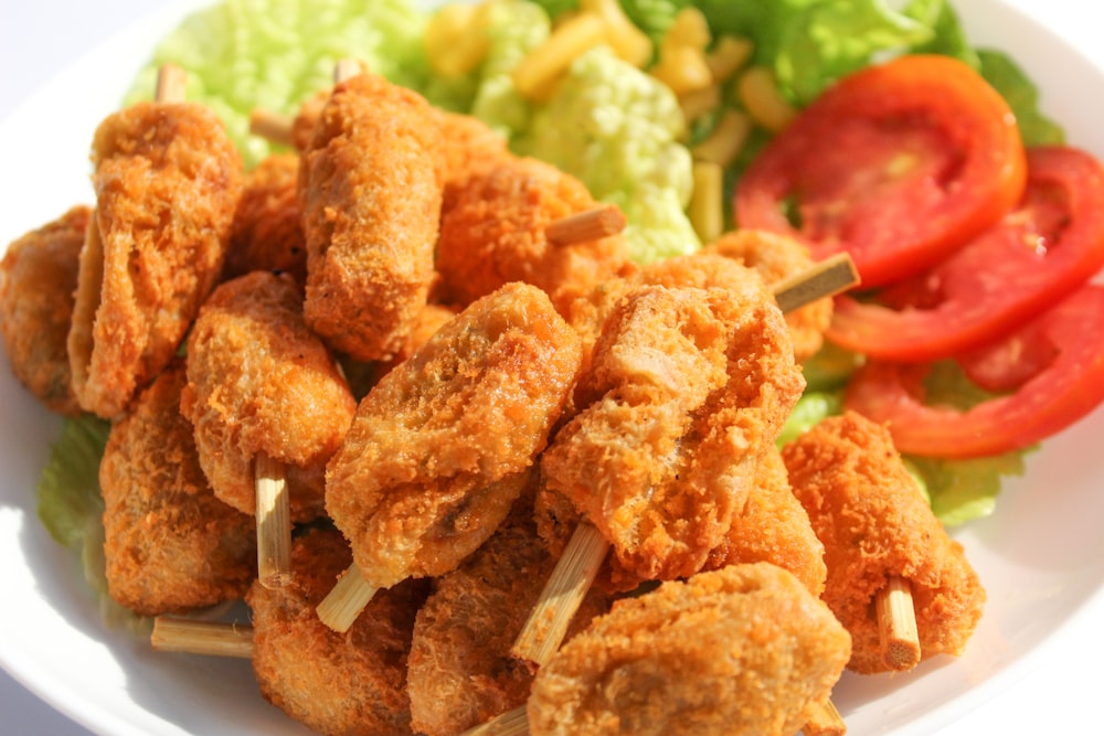 a close up of a plate of food with lettuce and tomatoes