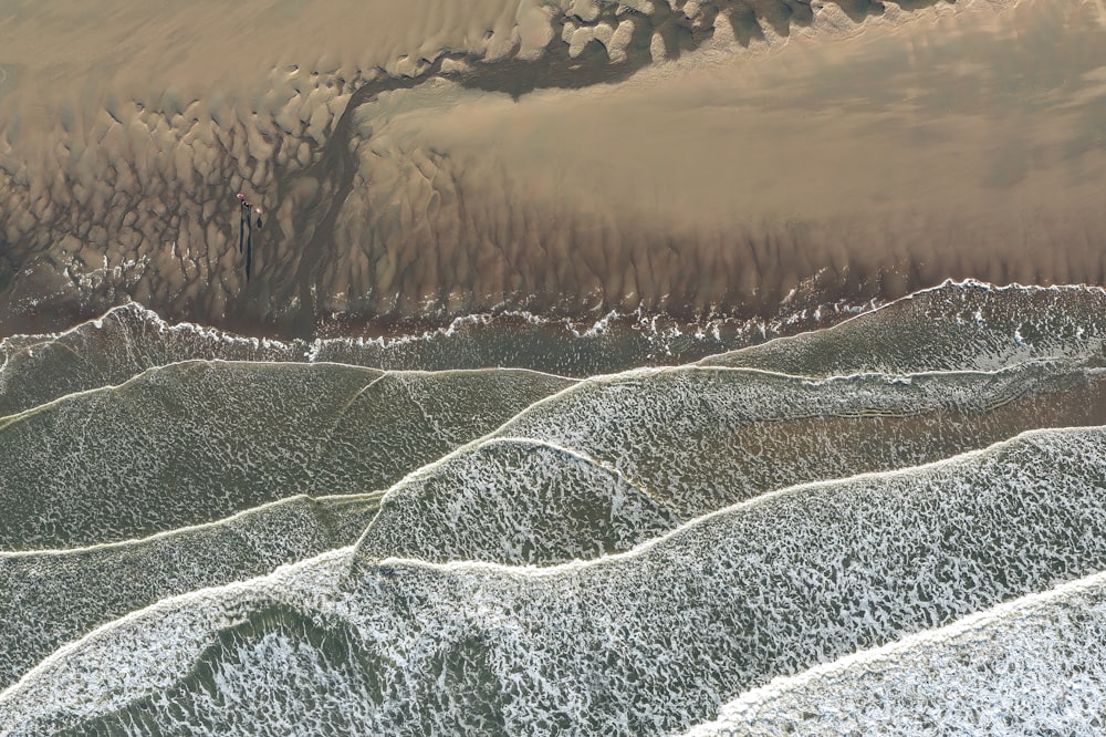 an aerial view of a sandy beach and ocean