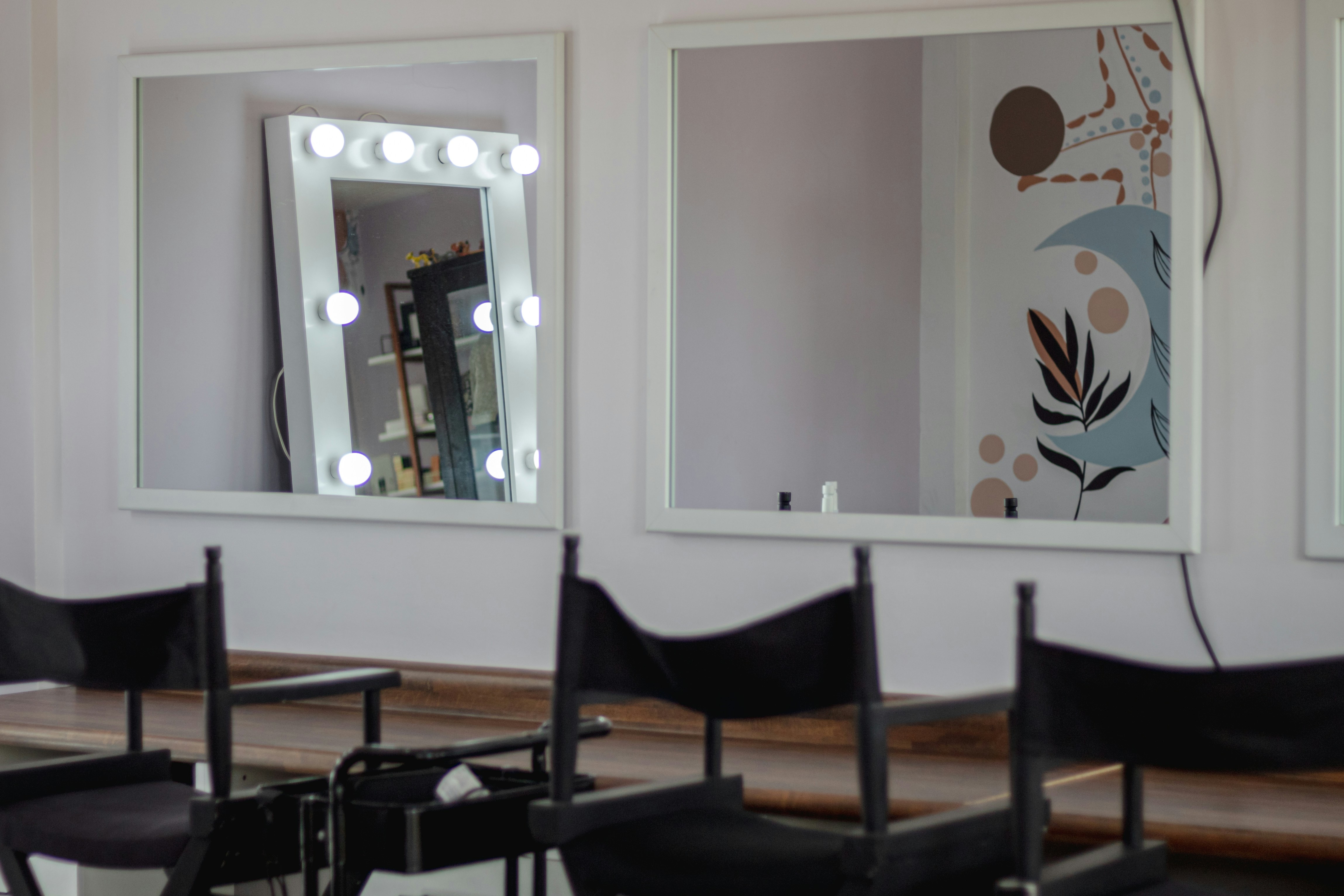 a hair salon with chairs and a mirror