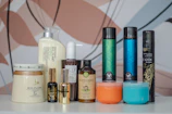 Various custom hair care product packaging samples displayed on a modern desk.