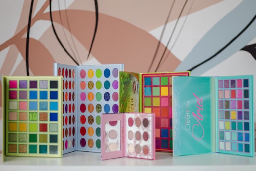 a group of colorful makeup products sitting on top of a table