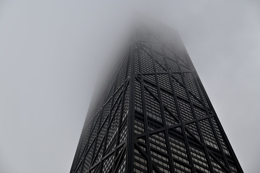 a very tall building with a lot of fog in the air