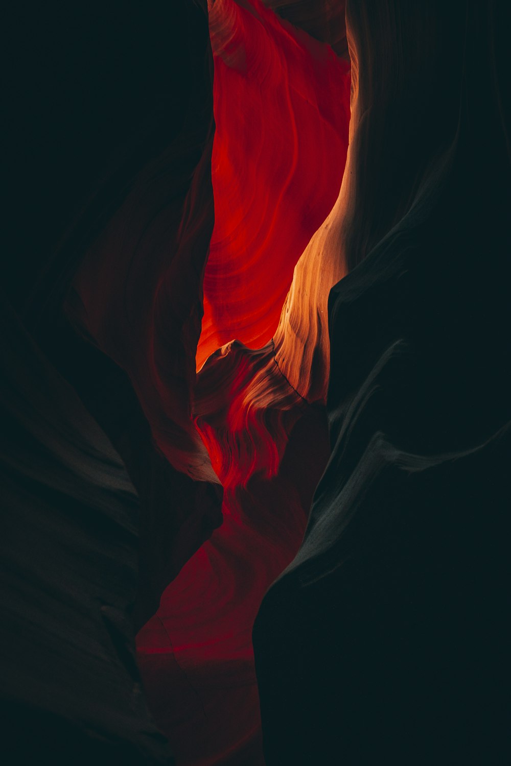 a red and black photo of a rock formation