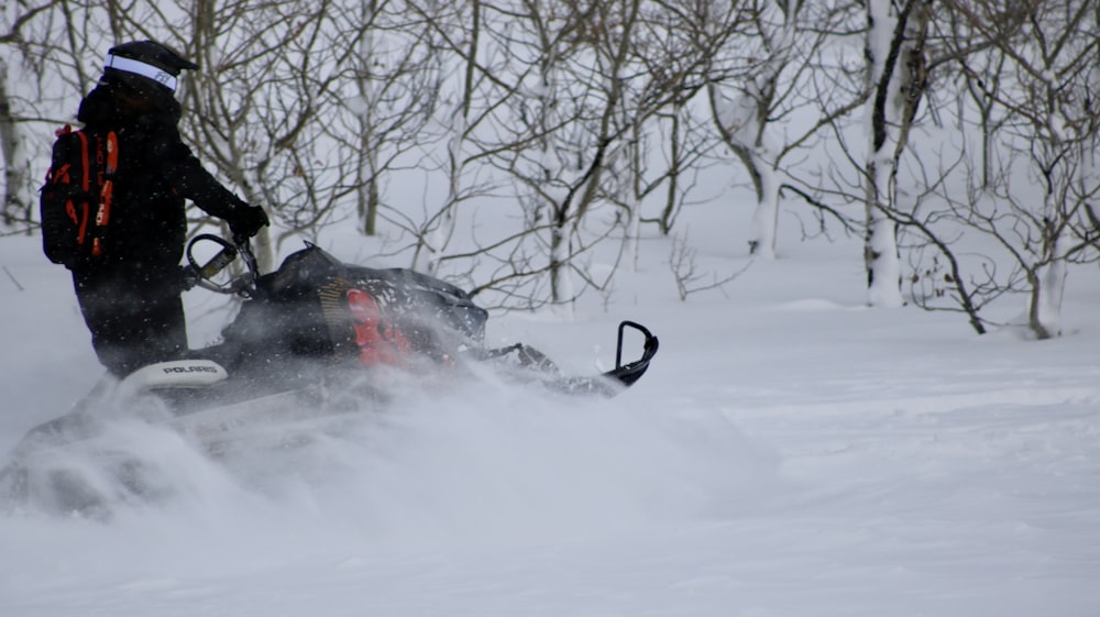 a person riding a snowmobile in the snow