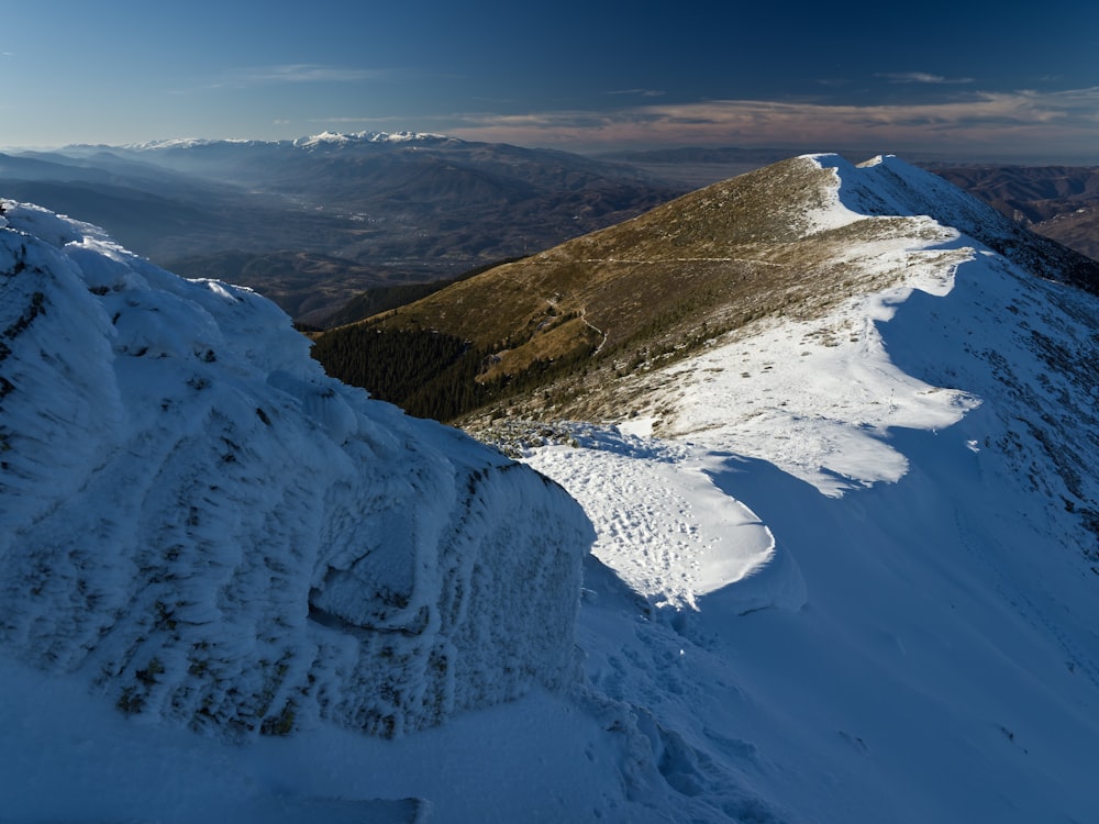 a view of a snowy mountain from the top of a mountain