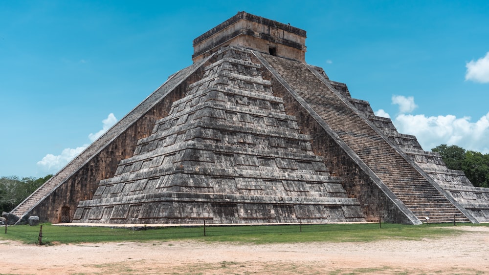 a large pyramid in the middle of a field