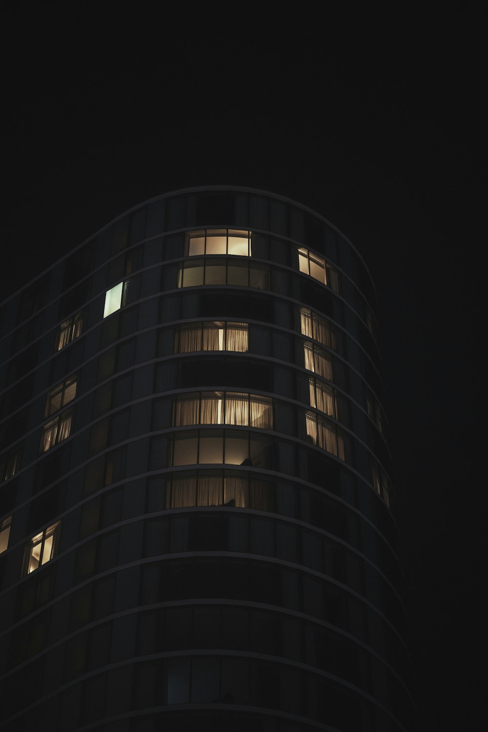 a very tall building with lots of windows at night