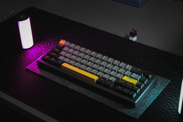 A sleek gaming deskmat adorned with intricate Witcher-themed artwork, set on a modern black and purple desk.