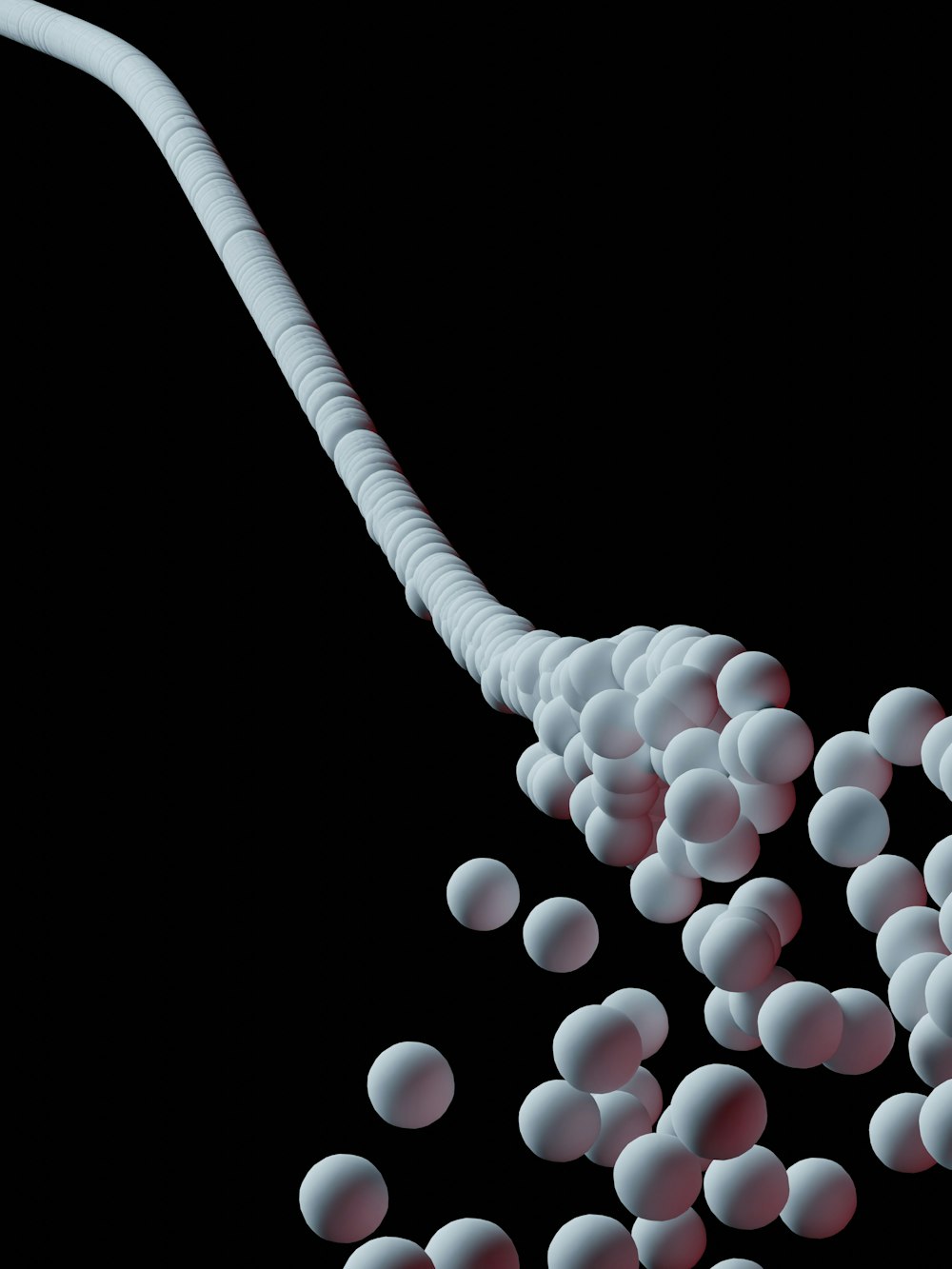 a spoon full of white balls on a black background