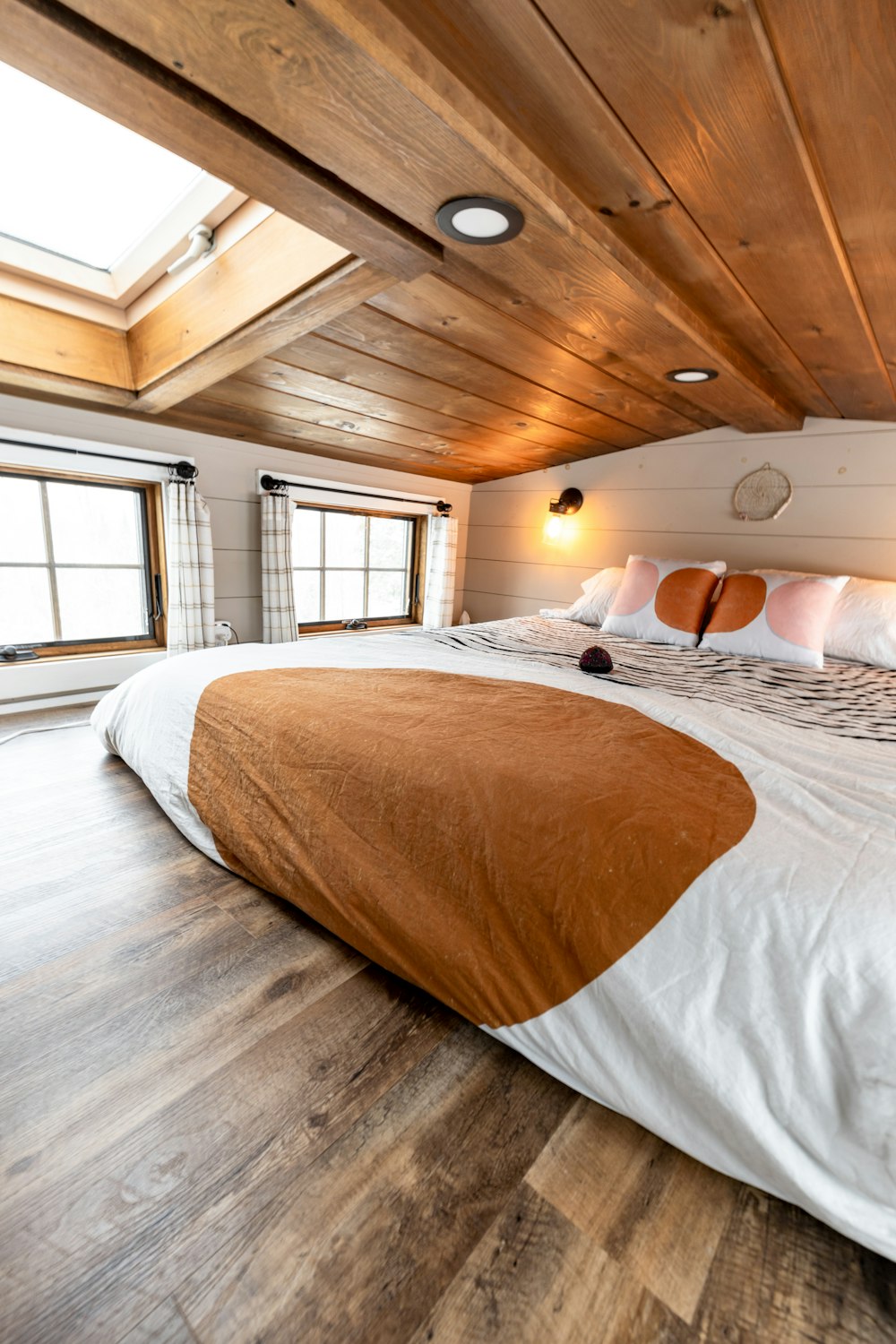 a large bed sitting in a bedroom on top of a hard wood floor
