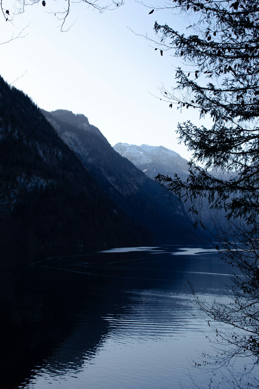 a body of water with mountains in the background