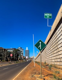 A delivery van navigating busy Nairobi streets under a bright sky.