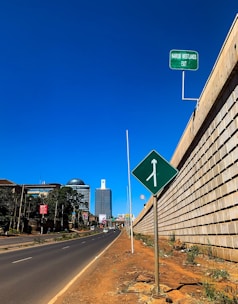 A delivery van navigating busy Nairobi streets under a bright sky.