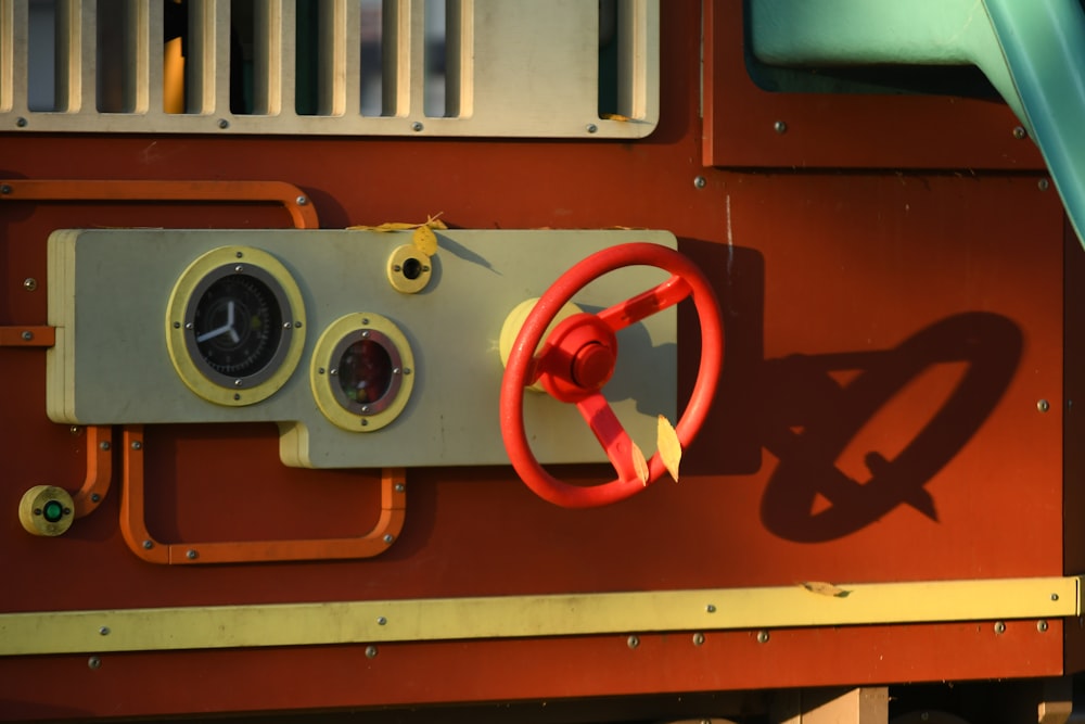 a steering wheel on a red and yellow train