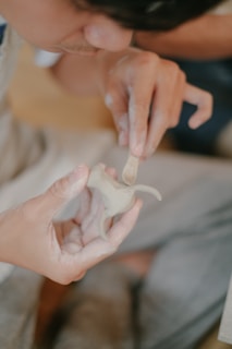 a person holding a small object in their hands