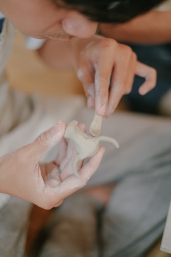a person holding a small object in their hands