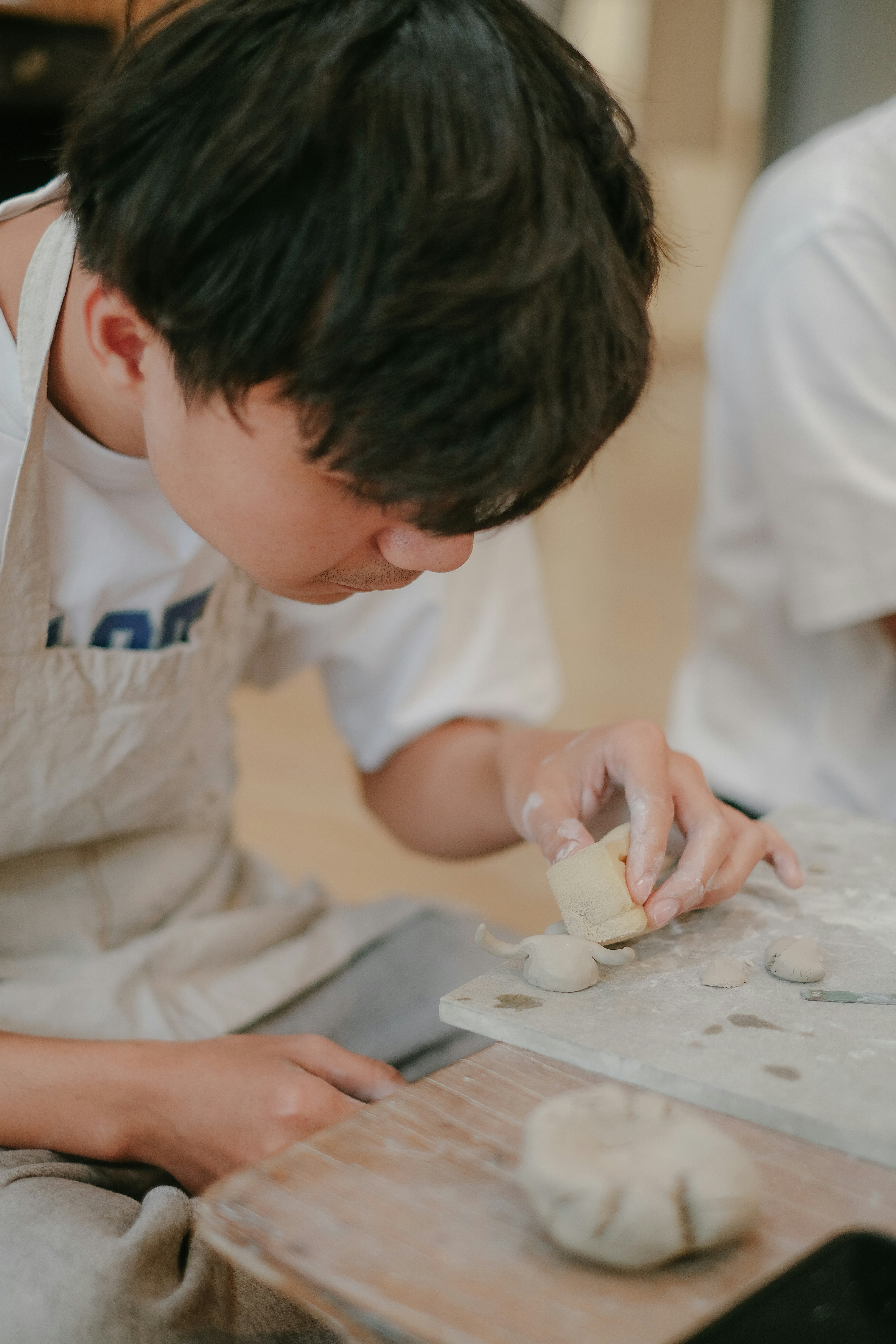 a young man is making food on a table
