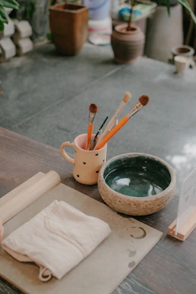 Handcrafted wooden crafts laid out with brushes and paints