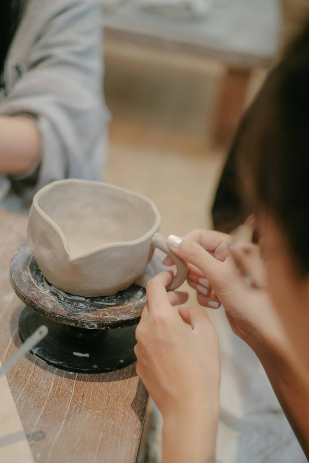 a woman is making a bowl on a table