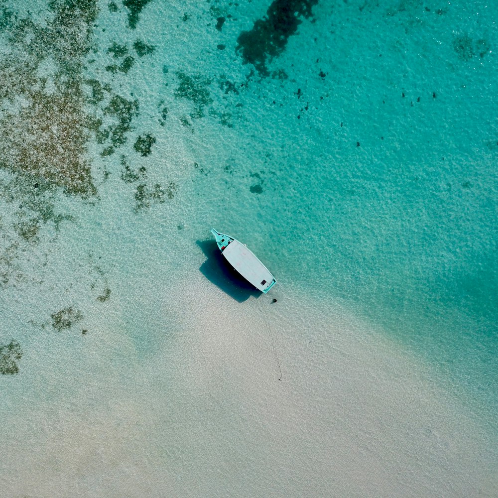 an aerial view of a boat on a beach