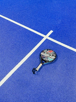 a tennis racket on a blue tennis court