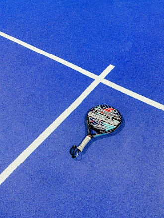 a tennis racket on a blue tennis court