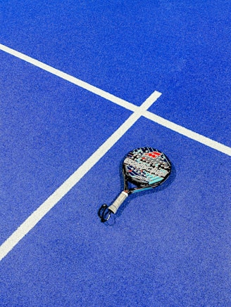 a tennis racket on a blue tennis court