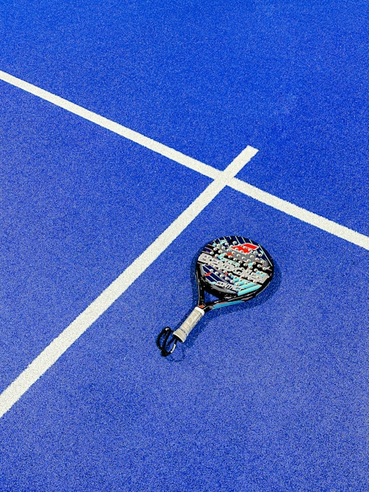 a tennis racket on a blue tennis court