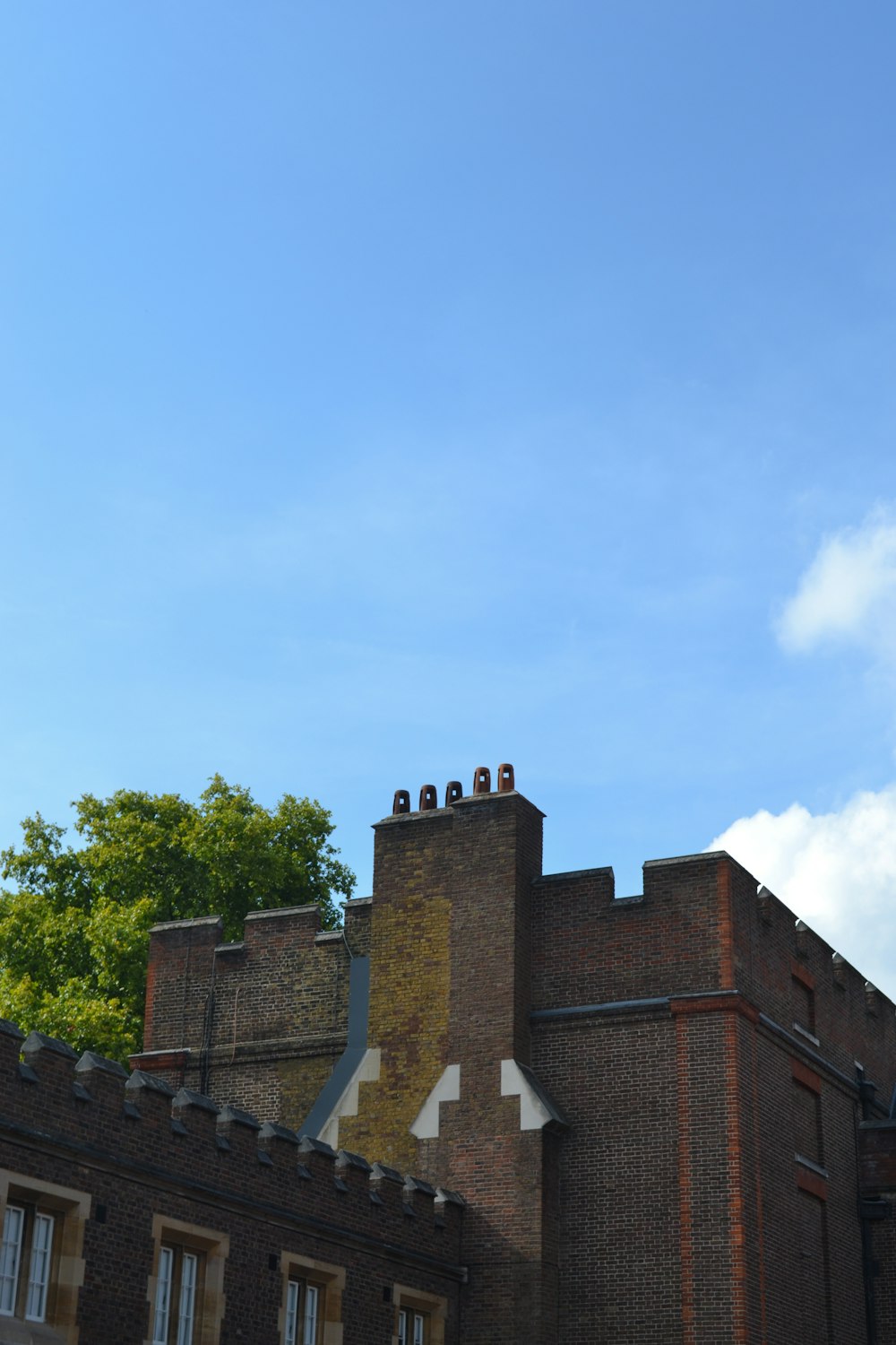 a tall brick building with a clock on it's side