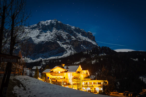 Exterior view of Himalaya Nivas at dusk with warm lights glowing against the mountain backdrop