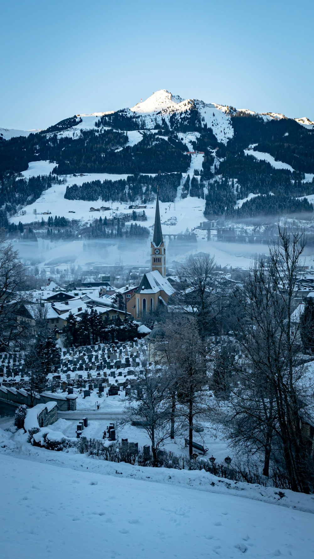 a snowy mountain with a church in the foreground
