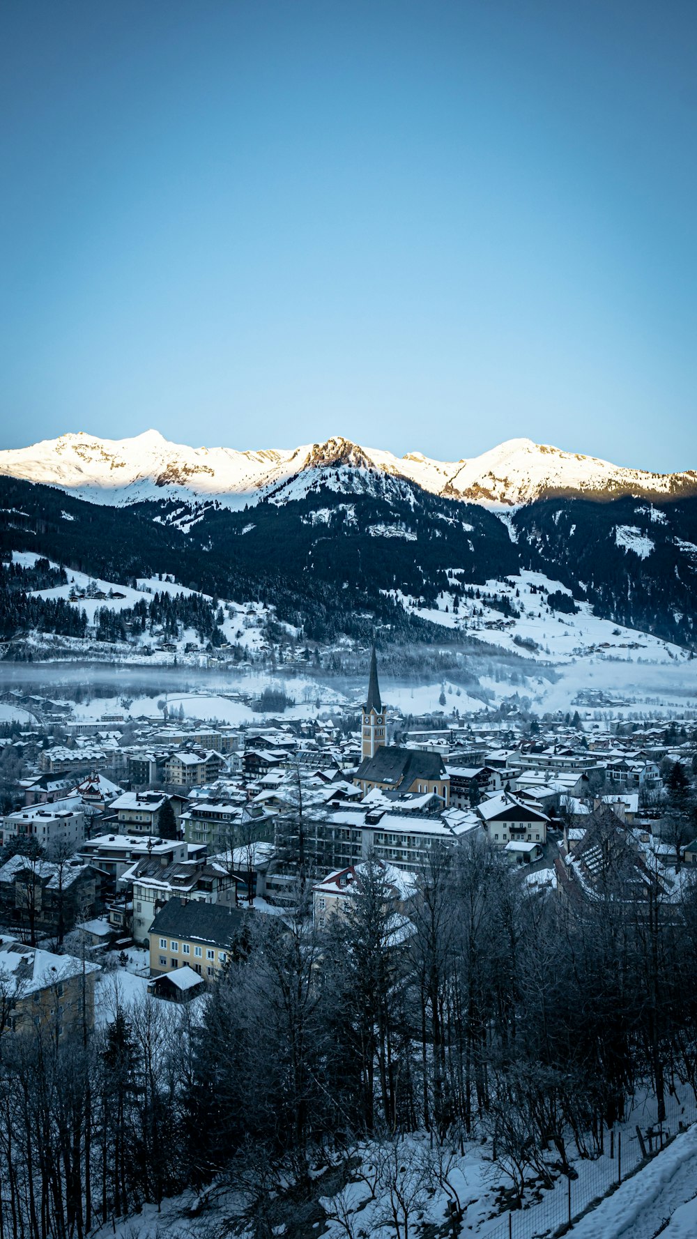 a town in the distance with mountains in the background